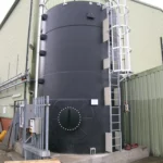 black chemical storage tank with access ladders